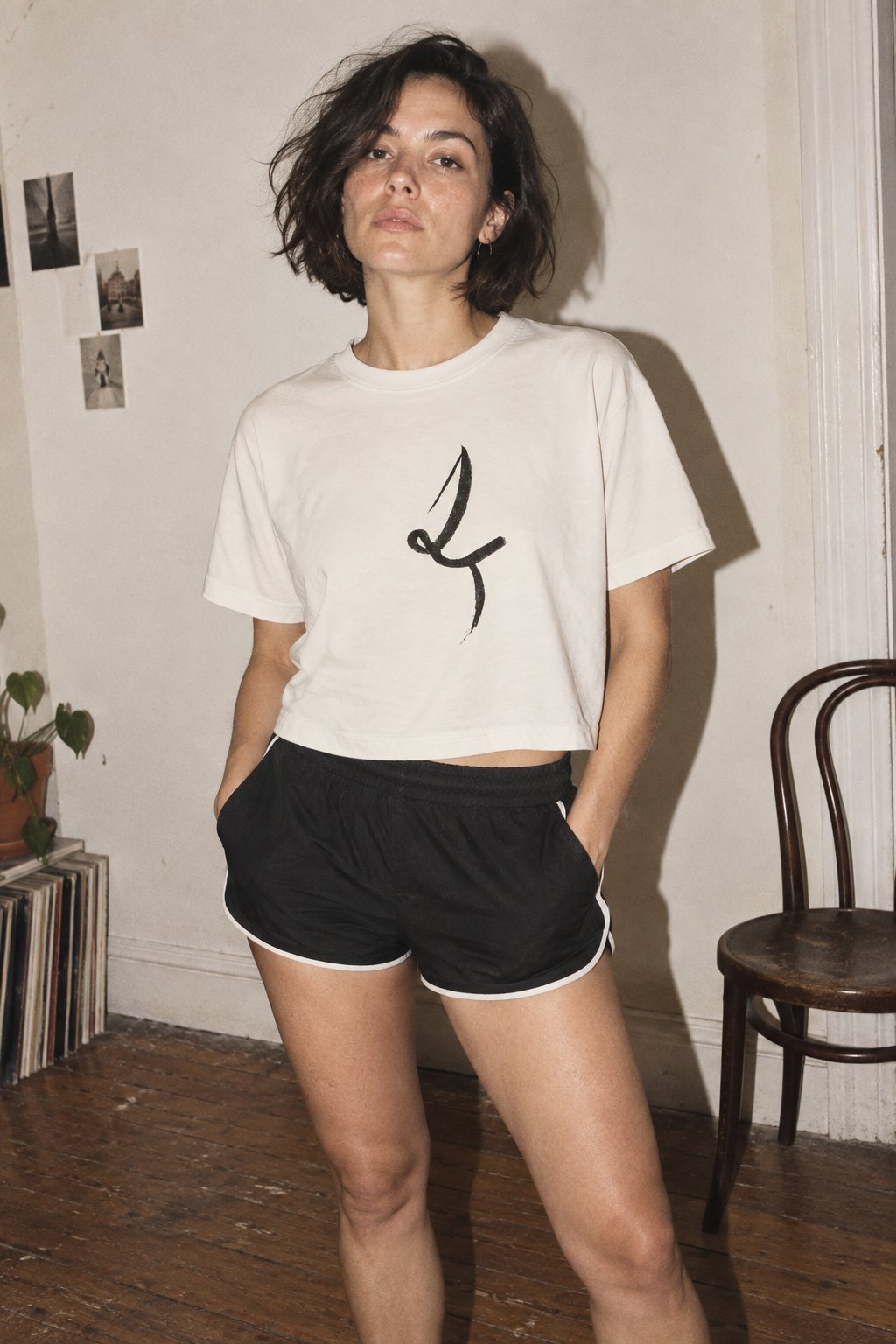 Faded Bone One Line cropped tee with black drawing, styled with black shorts