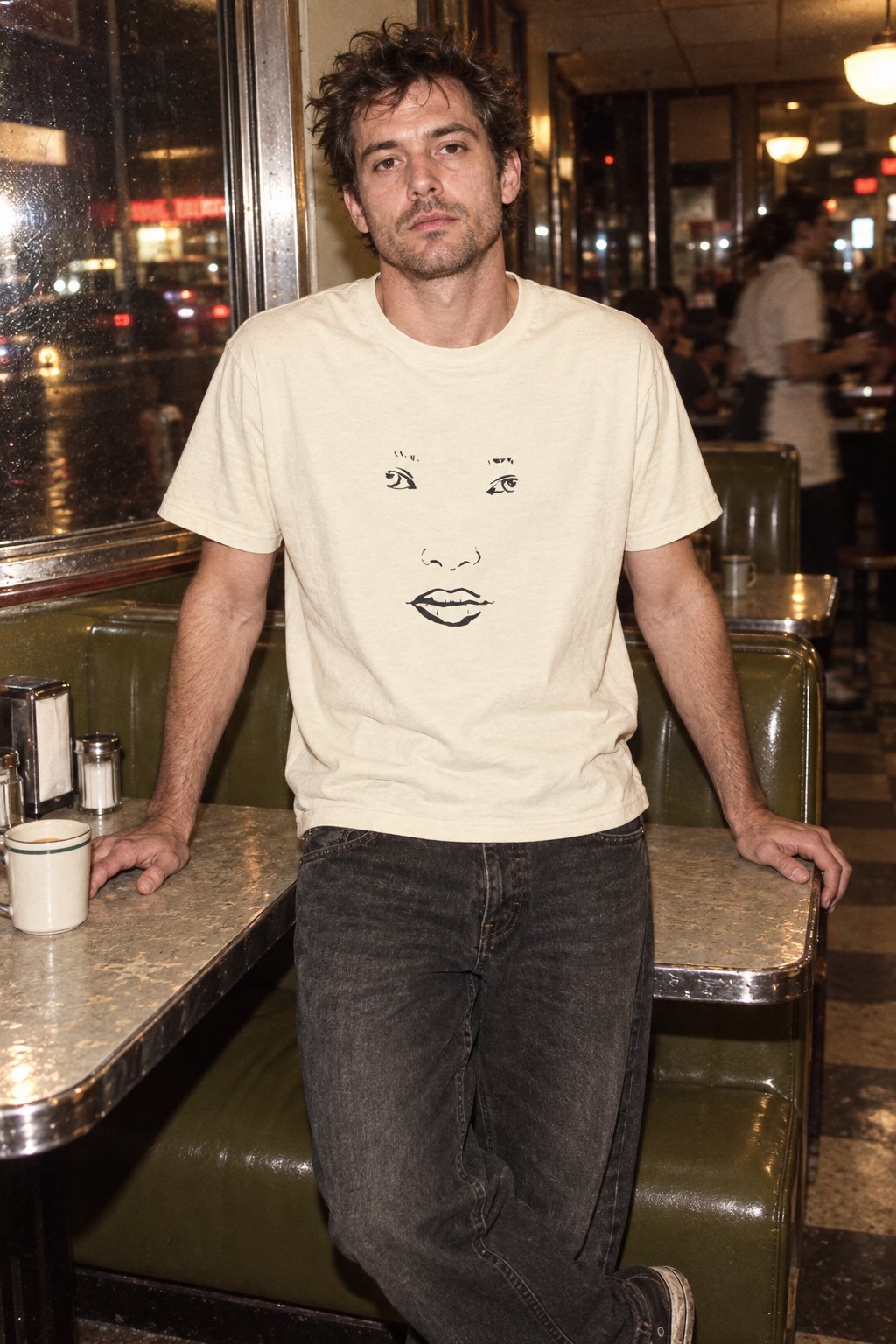 Faded Cream Face heavy tee with black face drawing, styled in a diner